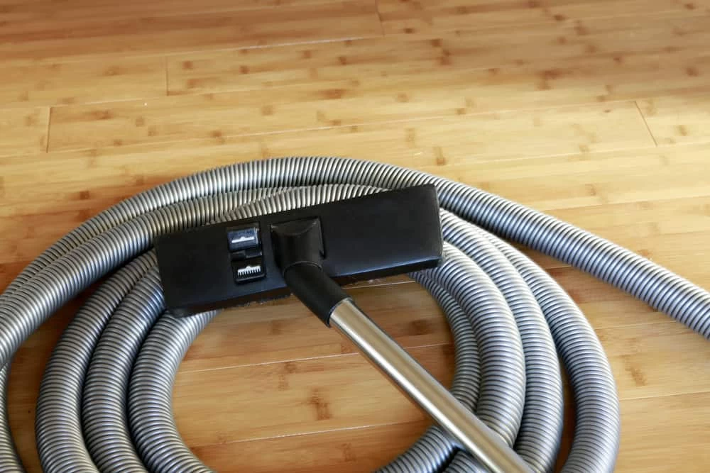 A vacuum cleaner on a wooden floor