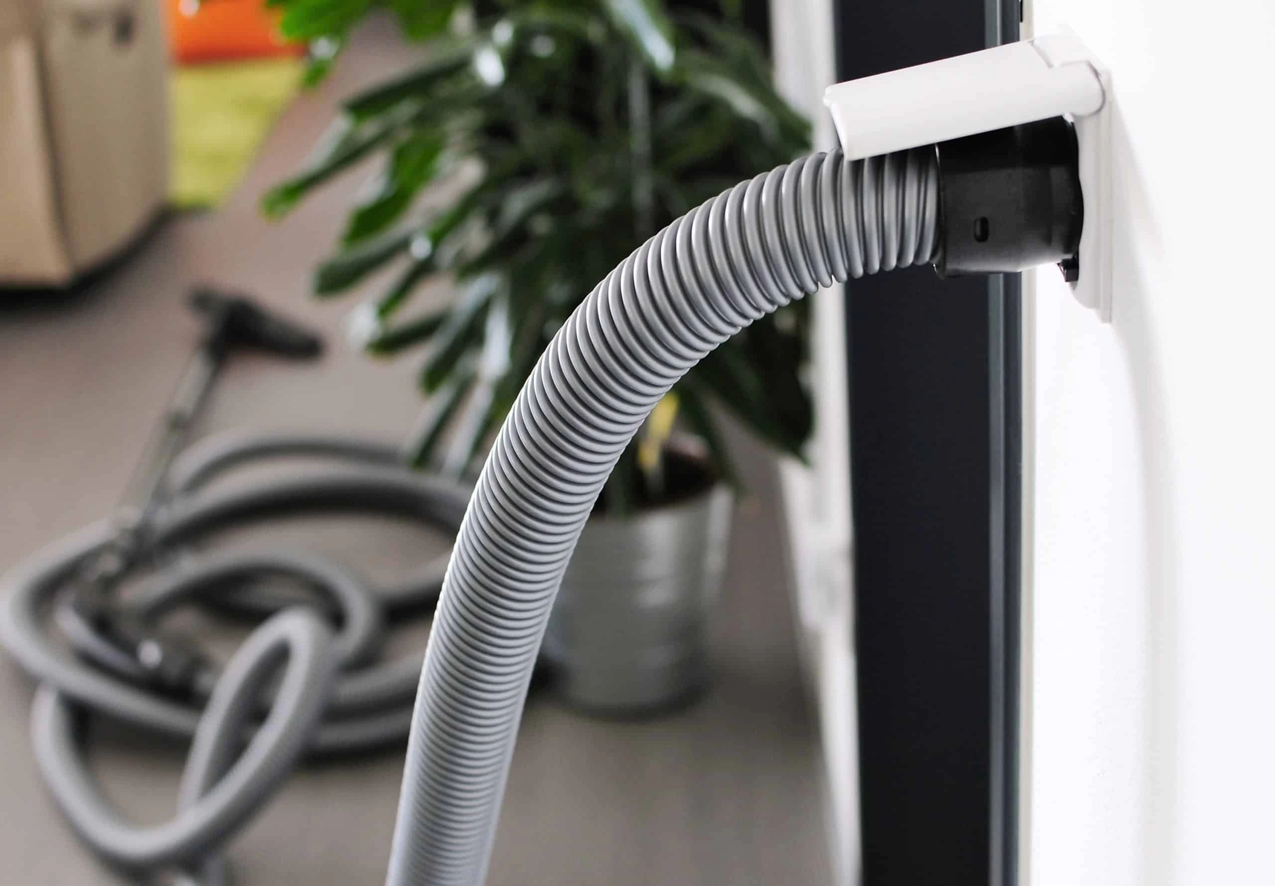 A vacuum cleaner is connected to a wall